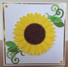 A handmade card with a flock covered sunflower. Made with yellow flock and bronze glitter.
