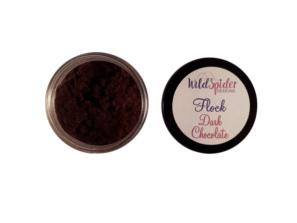 A pot of Dark Chocolate flock for crafts, open, with the lid next to it. 