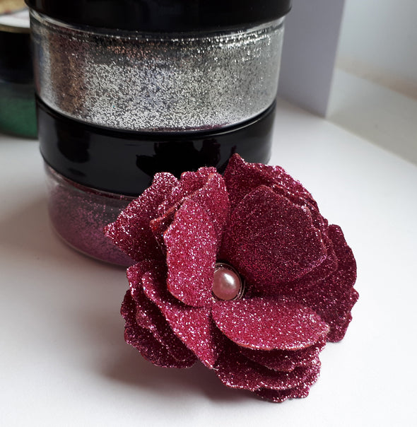 A handmade flowers created with glitter and Sticky Roll.