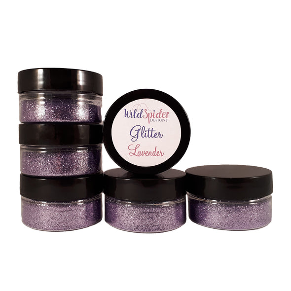 Lavender glitter for crafts in stacked up pots.
