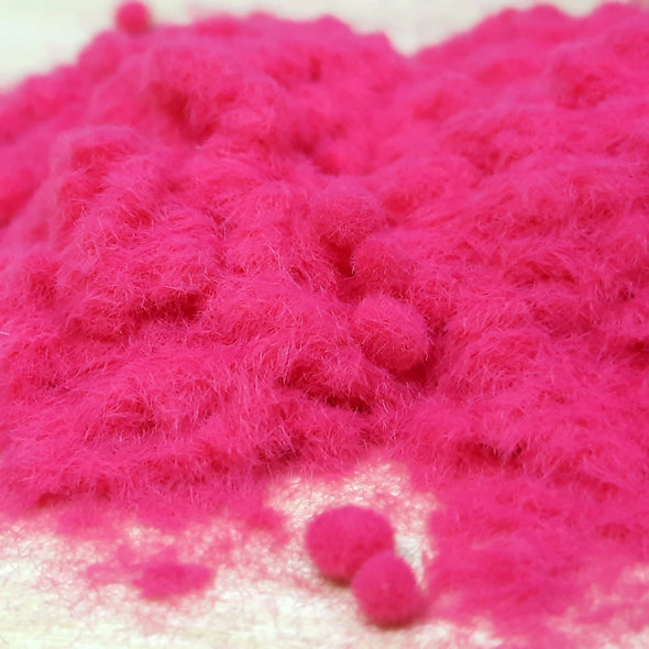 Close up view of Raspberry Flock for craft, poured on the table 